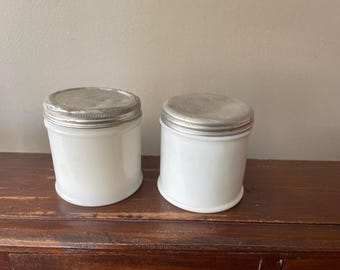 Antique jars, lot of 2, milk glass cold cream jars with original aluminum lids.  See photos.  Great for reusable containers for cream.