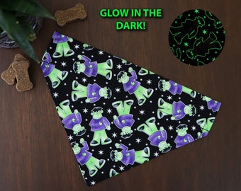 May include: Black dog bandana with a green and purple Frankenstein pattern. The bandana glows in the dark and says "Glow in the Dark!" on the image.