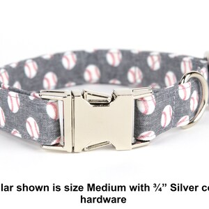 May include: A gray dog collar with white baseballs printed on it. The collar has a silver buckle and D-ring. *Collar shown is size Medium with 3/4" Silver color hardware*