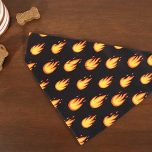 May include: A black dog bandana with a repeating pattern of orange flames.