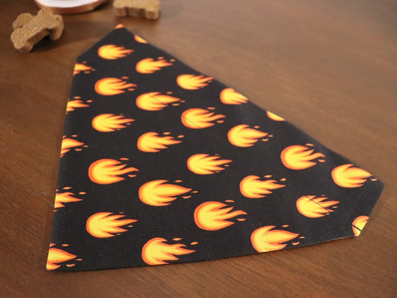 May include: A black dog bandana with a repeating pattern of orange flames.