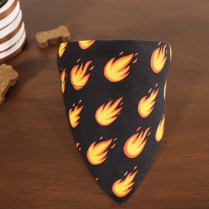 May include: Black dog bandana with a repeating pattern of orange flames.
