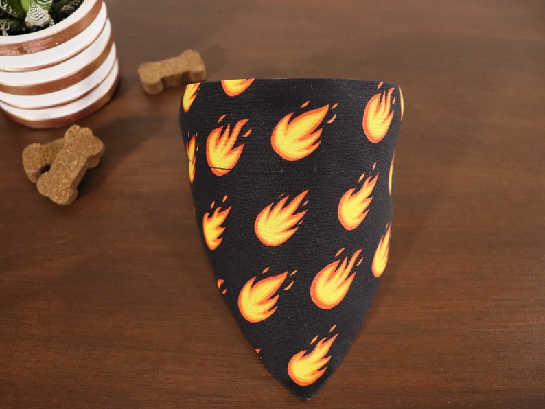 May include: Black dog bandana with a repeating pattern of orange flames.