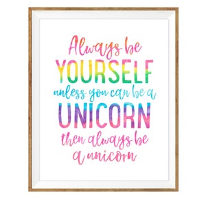 May include: A framed print with the text "Always be YOURSELF unless you can be a UNICORN then always be a unicorn." The text is in a colorful watercolor style, with a white background and a wooden frame.