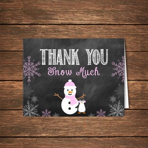 May include: A thank you card with a chalkboard background featuring a snowman and penguin. The text on the card reads "Thank You Snow Much".