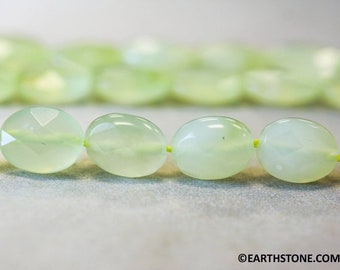 May include: A strand of light green oval-shaped gemstone beads. The beads are strung on a thin yellow thread.