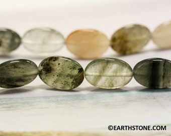 May include: A strand of oval-shaped green and clear quartz beads. The beads have a cloudy, translucent appearance with green inclusions.