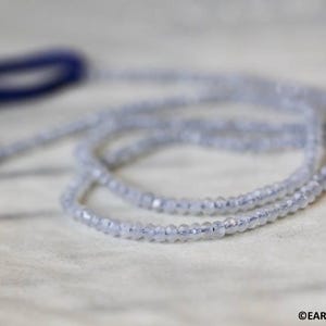 May include: A strand of light blue gemstone beads, strung together to form a necklace or bracelet. The beads are small and uniform in size, creating a delicate and elegant look.