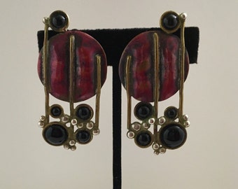 Red copper circle clip earrings with brass wire accents and bubbles and black onyx stones.
