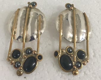 Sterling silver circle stud earrings with brass wire accents and black onyx and hematite stones