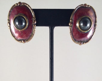 Red copper oval stud earrings with brass accents and hematite.