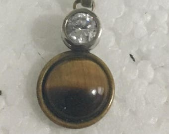 Sterling silver charm with brass accents and tiger's eye and cubic zirconia