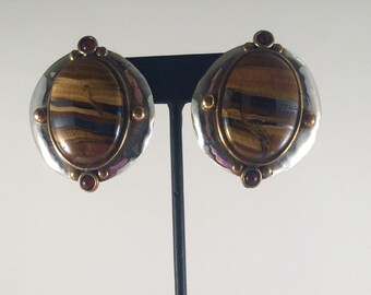 Sterling silver oval stud earrings with brass accents, tiger's eye and carnelian.