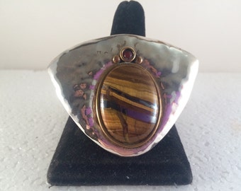 Sterling silver pendant/pin with brass accents, tiger's eye and carnelian.