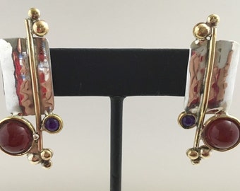 Sterling silver rectangle stud earrings with brass accents and carnelian and amethyst stones.