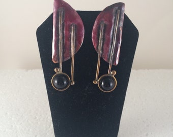 Red copper half moon stud earrings with brass accents and black onyx.
