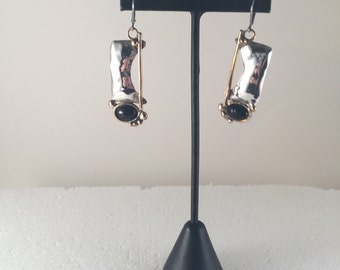 Sterling silver lever back dangle earrings with brass accents and black onyx.