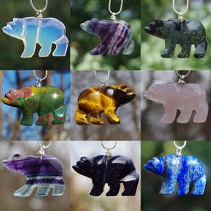 May include: Nine different gemstone bear pendants on silver chains. The bears are carved from various stones, including amethyst, tiger's eye, green aventurine, rose quartz, blue lapis lazuli, and more.