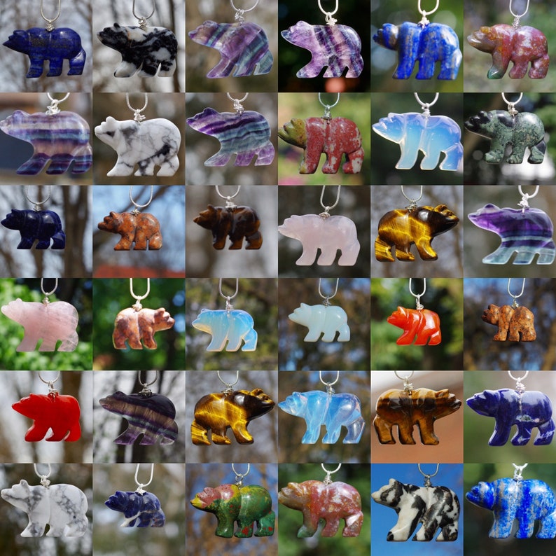 May include: A collection of 36 bear-shaped pendants made from various types of gemstones, including amethyst, fluorite, tiger's eye, and opal. Each pendant is strung on a silver chain.