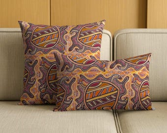 May include: Two throw pillows featuring a repeating pattern of stylized turtles in shades of orange, yellow, deep red, and dark purple. The square and rectangular cushions display intricate line work and dot details across the entire surface.