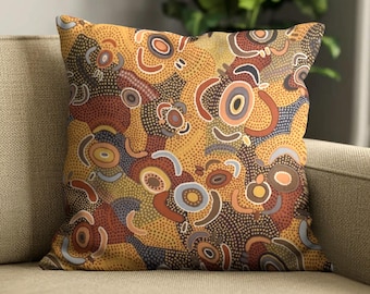 May include: A square throw pillow featuring an intricate dot art pattern in shades of mustard yellow, burnt orange, deep brown, and soft grey. The design consists of concentric circles, curved lines, and dense stippling across the fabric surface.
