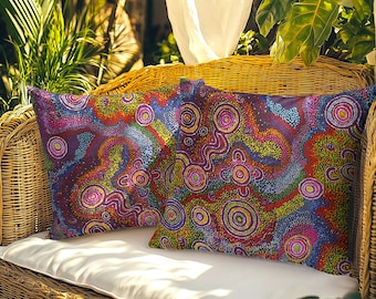May include: Two square throw pillows featuring a vibrant dot art pattern with concentric circles and wavy lines in shades of purple, red, yellow, green, and blue. The intricate design covers the entire surface of both pillows, creating a colorful visual texture.