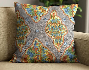 May include: A square throw pillow featuring a vibrant dot art pattern. The design consists of flowing, organic shapes filled with small dots in shades of blue, yellow, orange, and green, separated by textured gray areas of concentric circles.