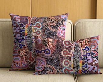 May include: Two throw pillows featuring a dark purple background with a vibrant, multi-colored pattern of abstract shapes, including U-shaped lines, circular motifs, and small dots in shades of red, blue, orange, and light purple across the fabric.