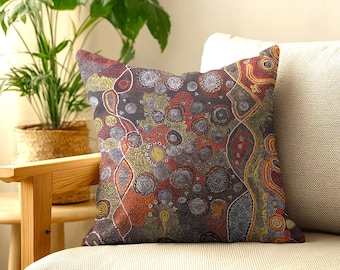 May include: A square throw pillow featuring a complex dot-art pattern in shades of dark gray, burnt orange, yellow, and white. The design consists of numerous circular motifs, swirling lines, and dense stippling that cover the entire surface.