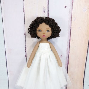 Handmade rag doll in a white removable ball gown.