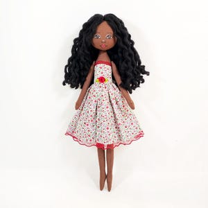 Little black doll in an flower dress, a gift for a girl, a decorative doll for room decoration