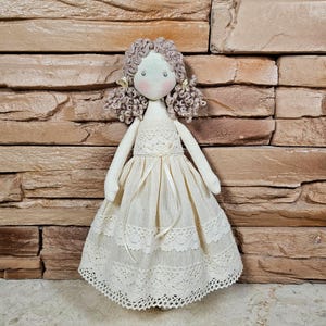 White little rag doll princess in a White dress with long white hair