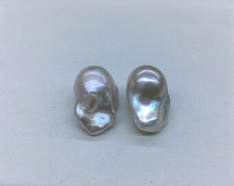 May include: Two large, irregular, white baroque pearls with iridescent sheen.