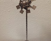 Vintage sterling pinwheel sculpture on wood base
