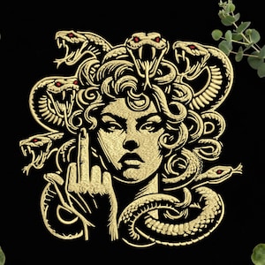 May include: Gold embroidered Medusa design on a black background. The image features Medusa with snakes for hair, red eyes, and a hand giving the middle finger. The design is detailed and intricate, with a bold and defiant expression.