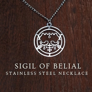 May include: A silver stainless steel necklace with a circular pendant displaying the Sigil of Belial. The pendant is suspended from a fine chain, set against a dark wood grain backdrop. The text "SIGIL OF BELIAL STAINLESS STEEL NECKLACE" is shown below.
