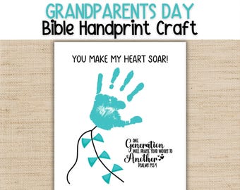 May include: A white rectangular card featuring a teal handprint graphic with a black line drawing of a kite tail. The text reads: YOU MAKE MY HEART SOAR! ONE GENERATION WILL PRAISE YOUR WORKS TO ANOTHER PSALMS 145:4 HAPPY GRANDPARENTS DAY!