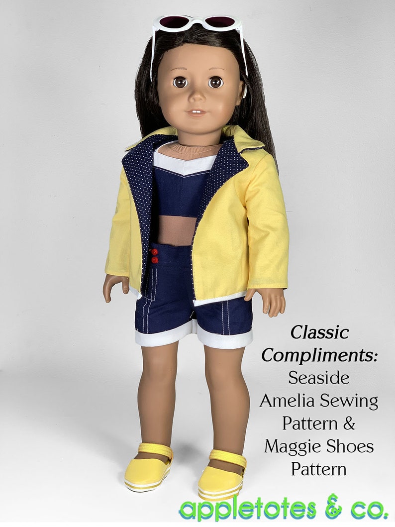 May include: A doll wearing a yellow jacket with white polka dots, a blue and white striped top, blue denim shorts with white trim, and yellow sandals. The doll is wearing white sunglasses and has brown hair. The text "Classic Compliments: Seaside Amelia Sewing Pattern & Maggie Shoes Pattern appletotes & co." is below the doll.