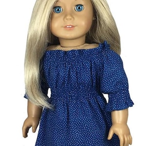 May include: A doll wearing a blue and white polka dot off-the-shoulder dress with a ruffled neckline and 3/4 sleeves. The doll has blonde hair and blue eyes. The dress is made for 18-inch dolls. The image includes the text "appletotes & co."