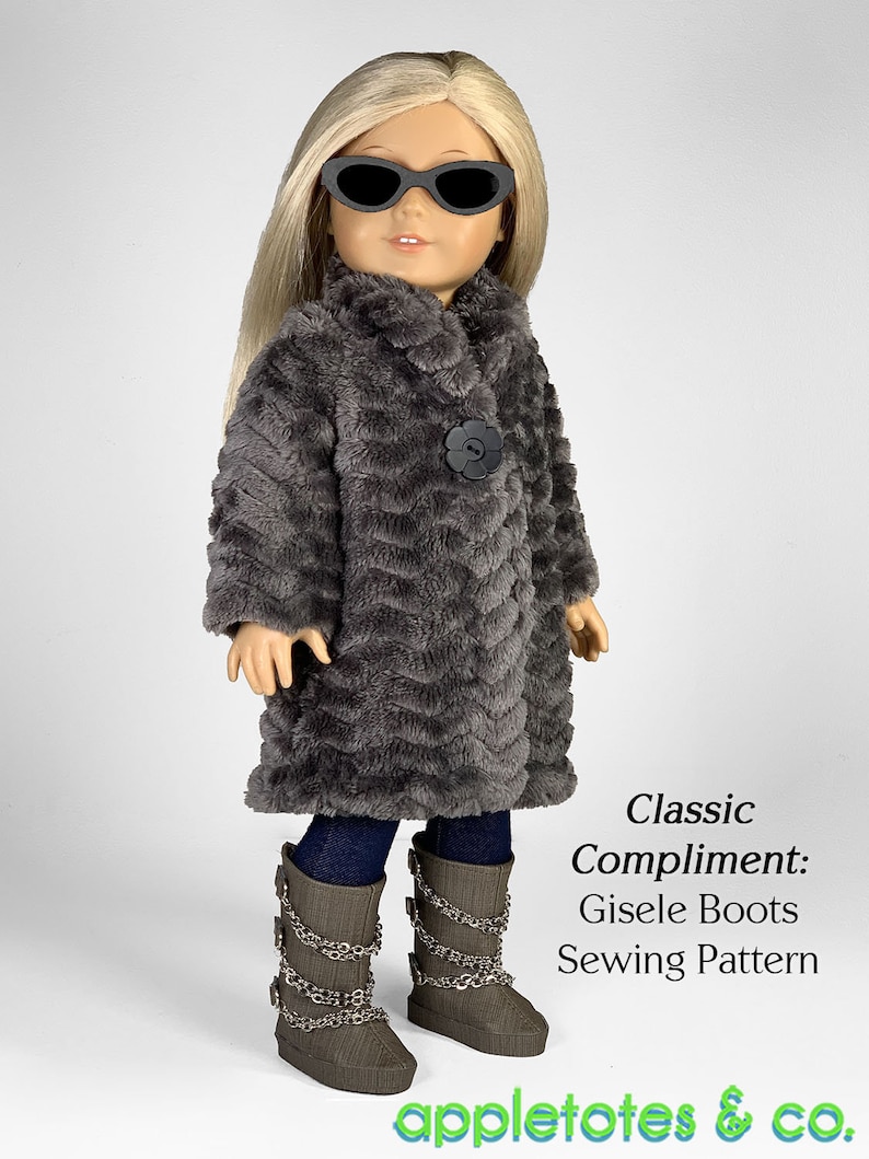 May include: A gray faux fur coat with a black button and a flower design. The doll is wearing blue jeans and gray boots with silver chains. The text "Classic Compliment: Gisele Boots Sewing Pattern" is below the doll. The text "appletotes & co." is at the bottom of the image.