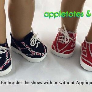 May include: Two pairs of doll-sized sneakers with white soles and red and blue embroidered designs. The text "appletotes & co." is visible above the shoes. The text "Embroider the shoes with or without Applique" is visible below the shoes.