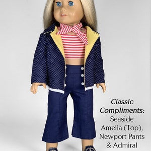 May include: A doll wearing a blue and white polka dot jacket with yellow trim, a red and white striped top, blue pants, and black shoes with an anchor design. The doll is wearing a red and white striped scarf. The text "Classic Compliments: Seaside Amelia (Top), Newport Pants & Admiral Shoes Patterns appletotes & co." is below the doll.
