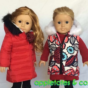 May include: Two dolls wearing winter clothing. The doll on the left is wearing a red puffer jacket with a black fur hood. The doll on the right is wearing a cream-colored vest with a floral print and a white fur hood. Both dolls are wearing red shirts and black pants.