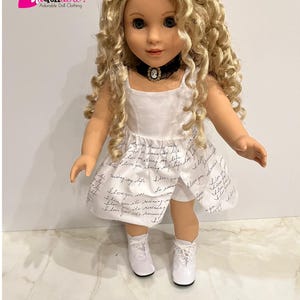 May include: A white doll dress with a black choker and white lace-up shoes. The dress has a handwritten message pattern that says "I love you" repeatedly.