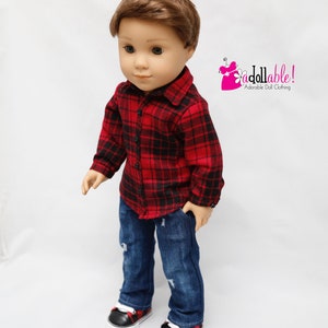 May include: A doll wearing a red and black plaid shirt, blue jeans, and black and red plaid sneakers. The doll has brown hair and blue eyes.