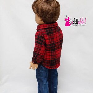May include: A doll wearing a red and black plaid shirt, blue jeans, and red and black plaid sneakers. The doll has brown hair and is looking to the left. The text "Addollable! Adorable Doll Clothing" is in the upper right corner of the image.