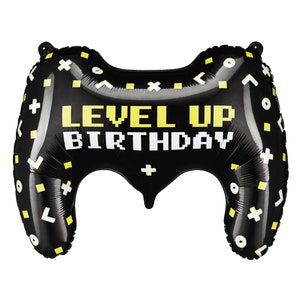 May include: Black and yellow balloon shaped like a video game controller with the text "Level Up Birthday" printed on it.