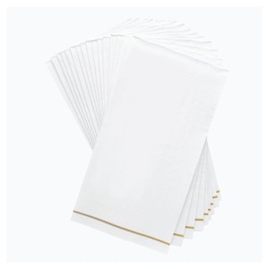 May include: A stack of white paper napkins with a subtle diamond pattern and a thin gold border. The napkins are rectangular and fanned out, showcasing their clean, crisp appearance. Ideal for formal events or everyday use.