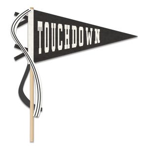 May include: A black triangular pennant flag attached to a light wooden dowel. The word TOUCHDOWN is printed in large white block letters across the center. A white ribbon with two thin black stripes is tied to the side of the wooden pole.