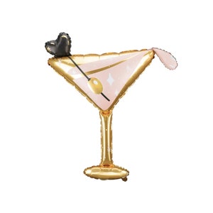 May include: A gold foil balloon shaped like a martini glass with a pink drink and a black heart-shaped olive garnish.